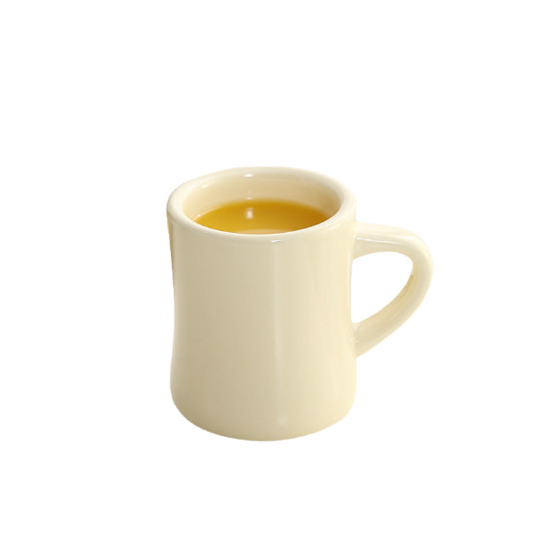 Thickened ceramic coffee cup with milk mark.