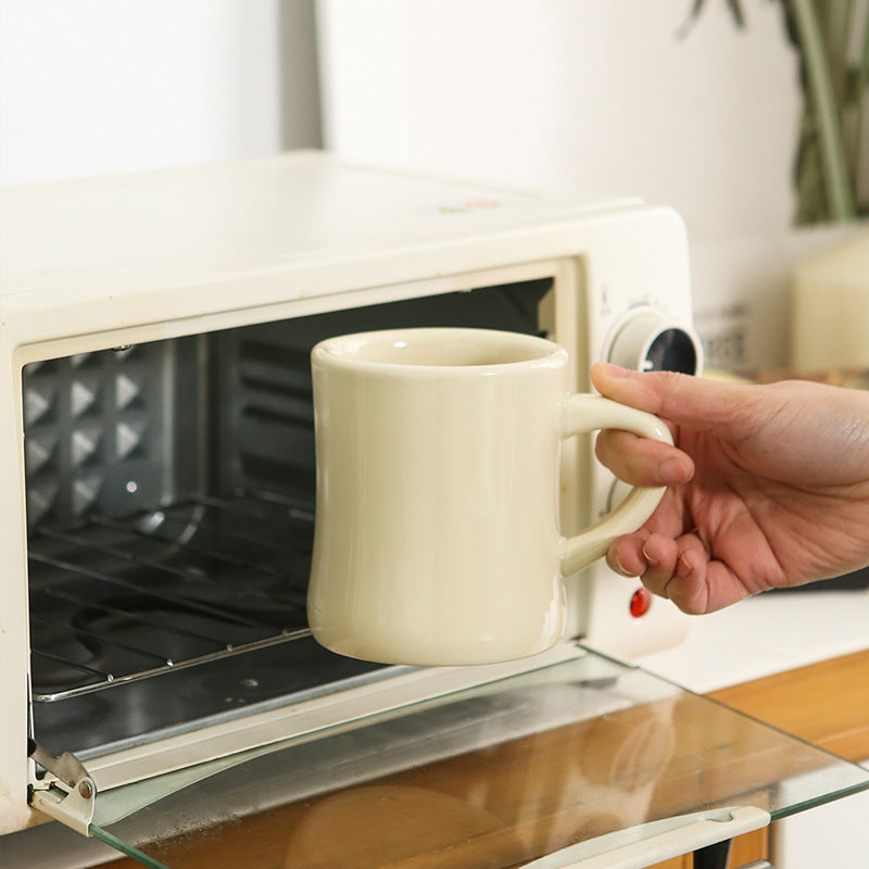 Thickened ceramic coffee cup with milk mark.