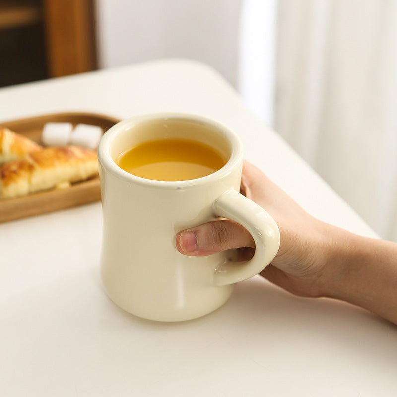 Thickened ceramic coffee cup with milk mark.