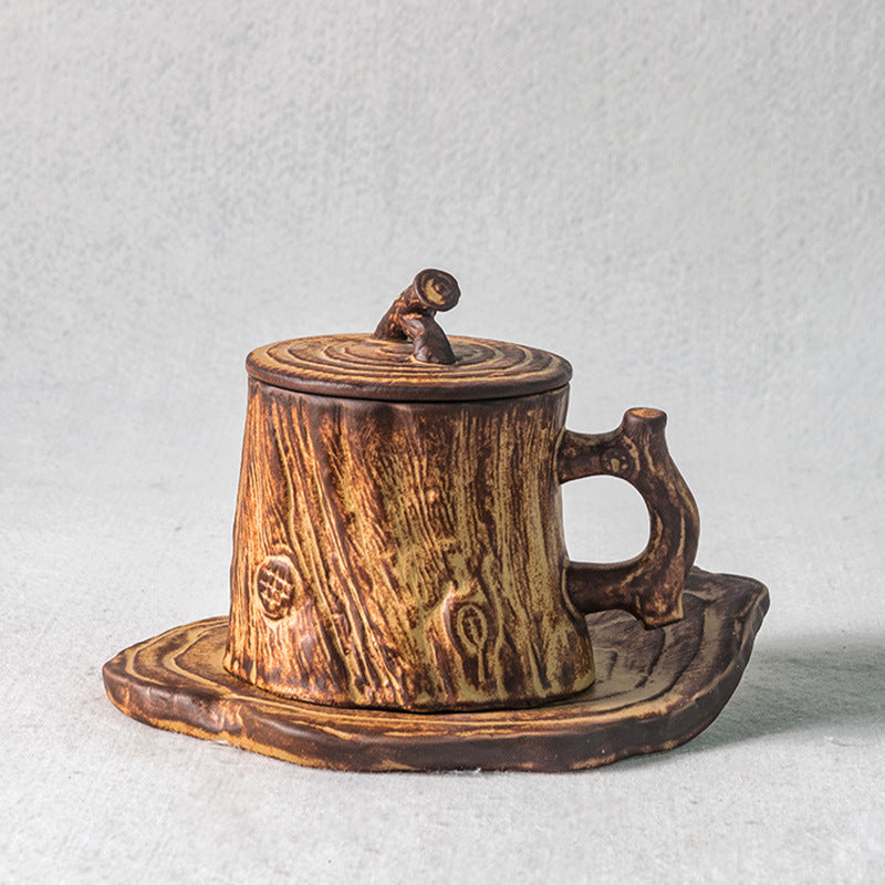 Handmade ceramic coffee cup with tree trunk design.