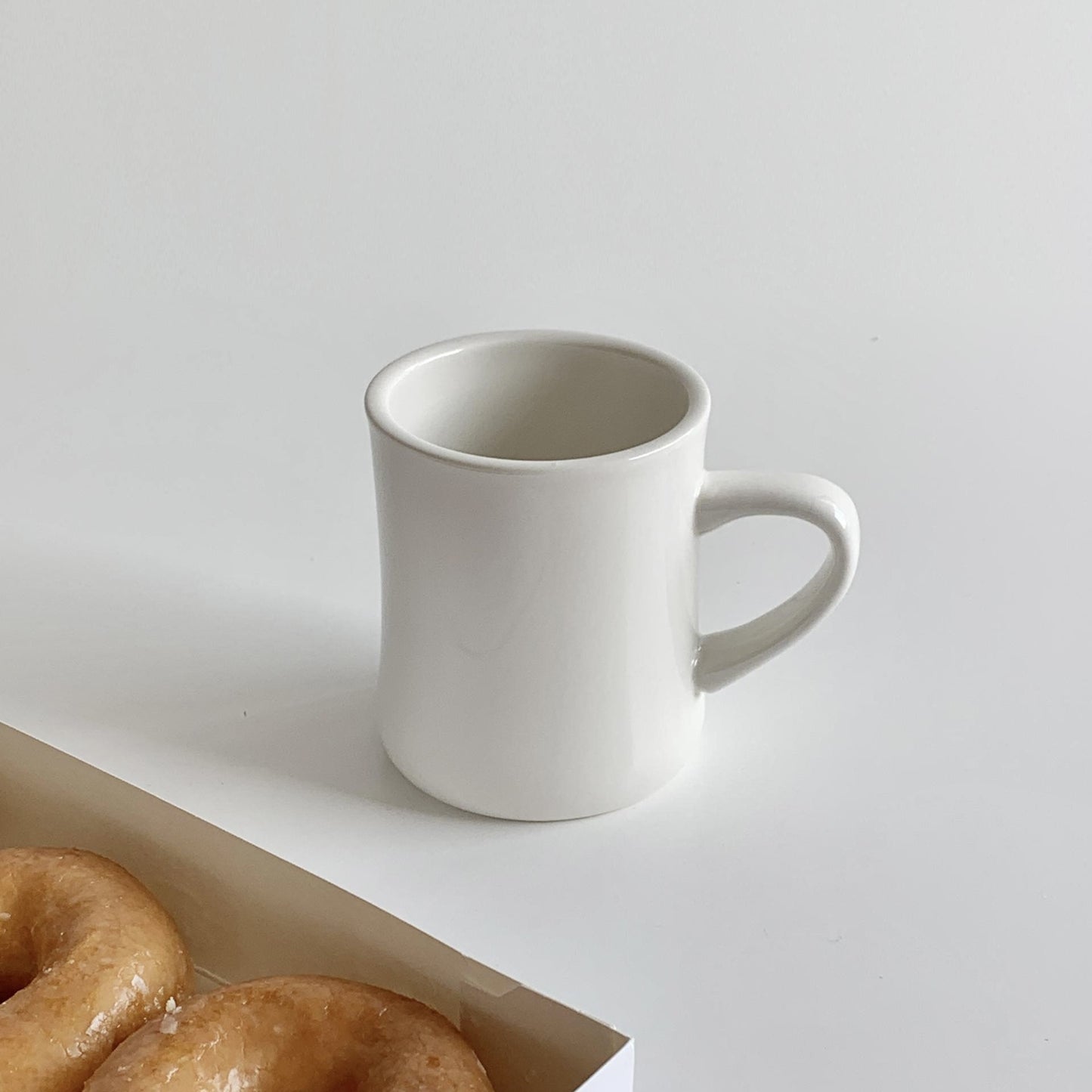 Thickened ceramic coffee cup with milk mark.